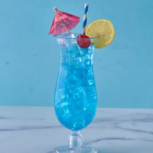 hurricane glass with lemon and cherry, filled with blue drink
