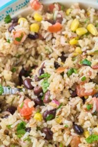 serving spoon scooping out rice salad.