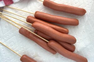 hot dogs with skewers.
