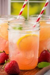 closeup of strawberry lemonade in mason jar.