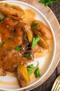 close up view of crockpot pork chops cooked with apples.