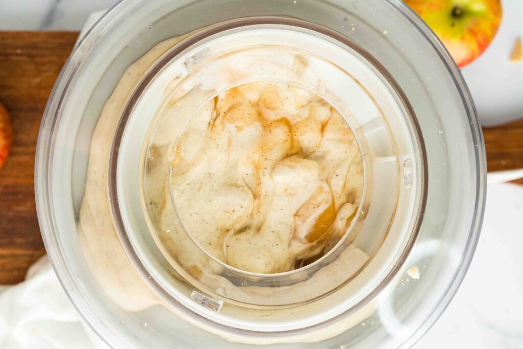ice cream maker with apple pie filling being mixed in.