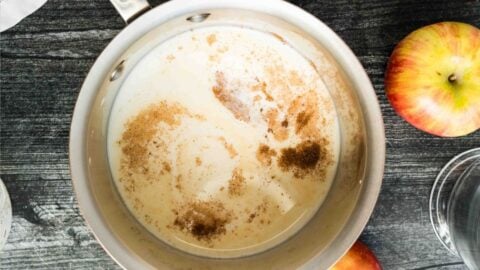 saucepan of milk with cinnamon and caramel.