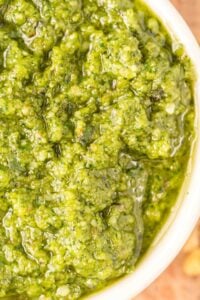 finished basil walnut pesto in small white dish.