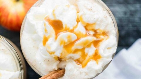 overhead view whipped cream, caramel, and cinnamon stick