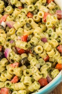 cold pesto pasta salad in mixing bowl.