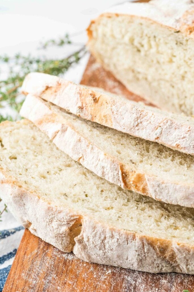 loaf of herb olive oil bread on wooden board.