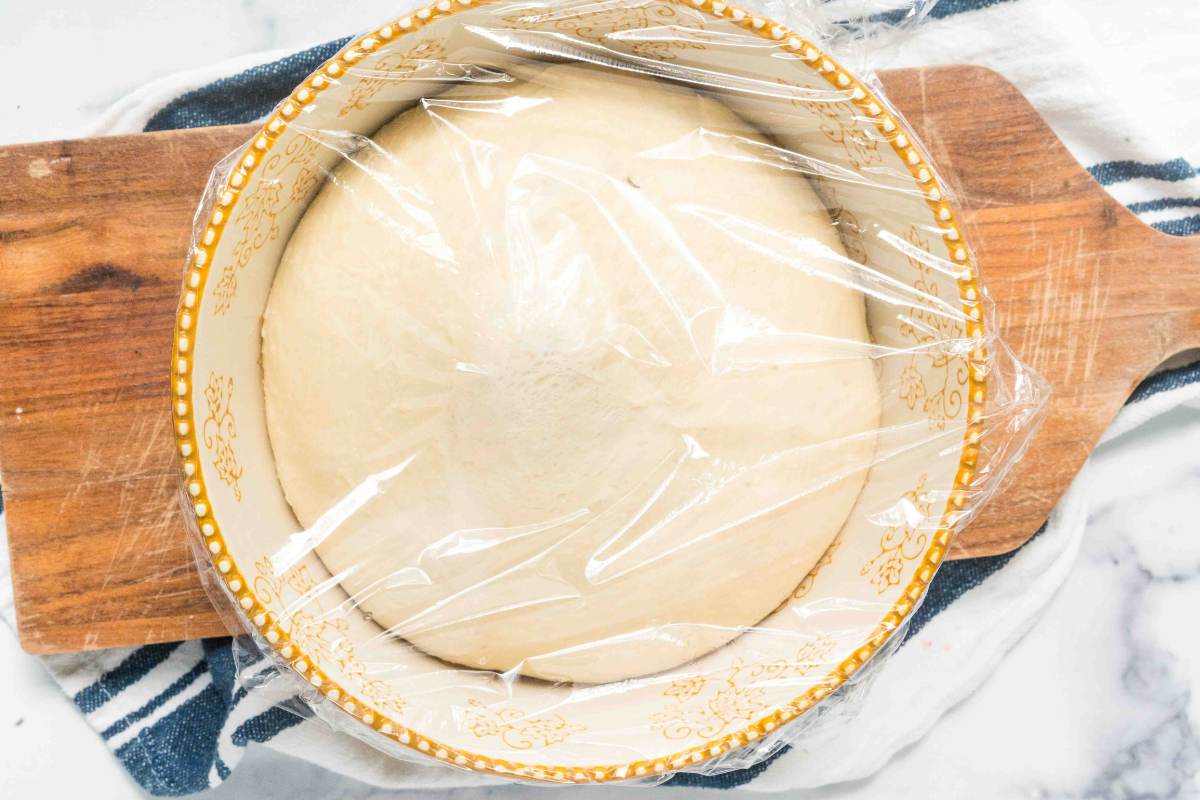 risen bread dough in large bowl.