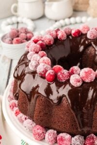 chocolate bundt cake with sugared cranberries on top.