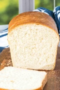 finished sandwich loaf with blue and white towel.