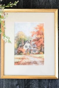 framed fall farmhouse on wooden surface.