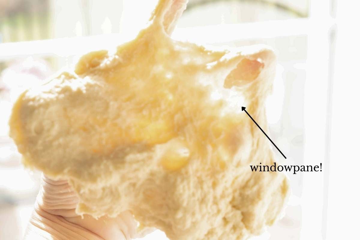 hand stretching out dough.