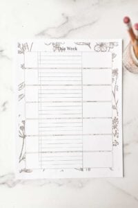 marble counter with printed weekly planner.