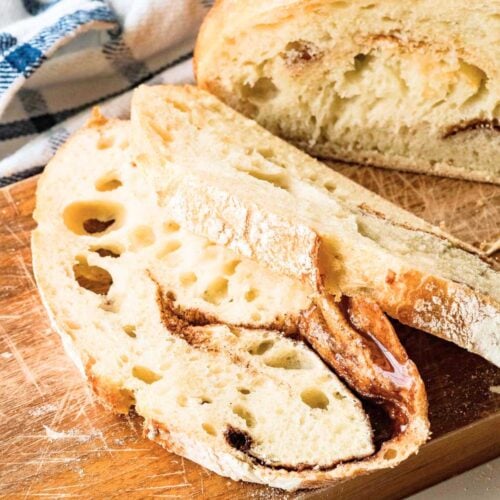 sliced loaf of round sourdough bread with cinnamon swirl.