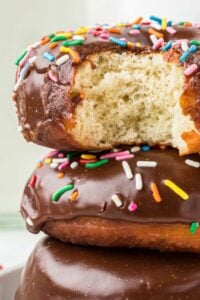 frosted fried doughnuts with sprinkles.