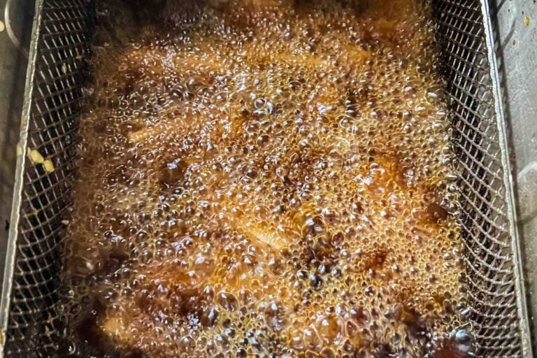deep fryer basket with potatoes.