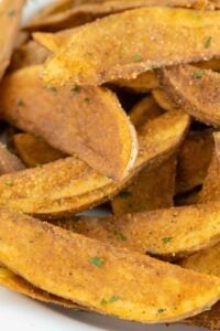 close up view of deep fried potato wedges.