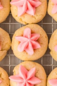 close up view of buttercream thumbprint cookies on rack.