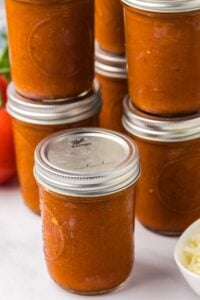 stacked mason jars of home canned pizza sauce