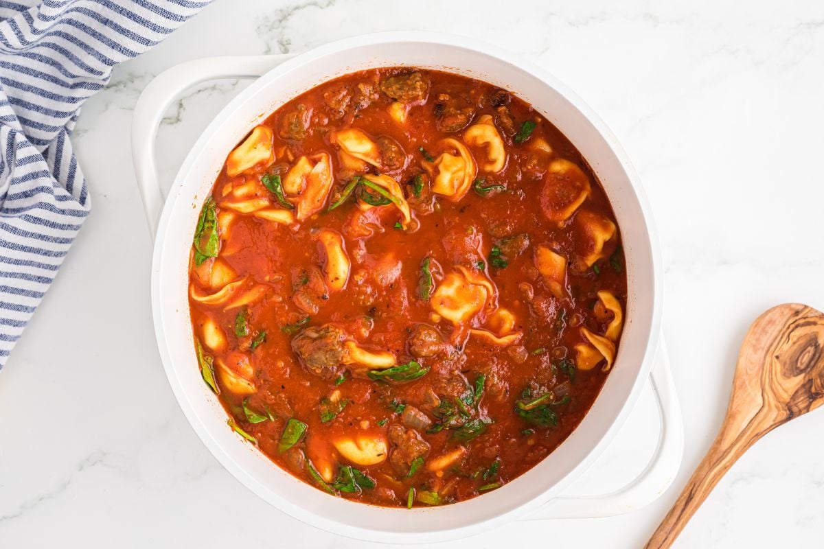 spinach and sausage added to pot with tortellini.