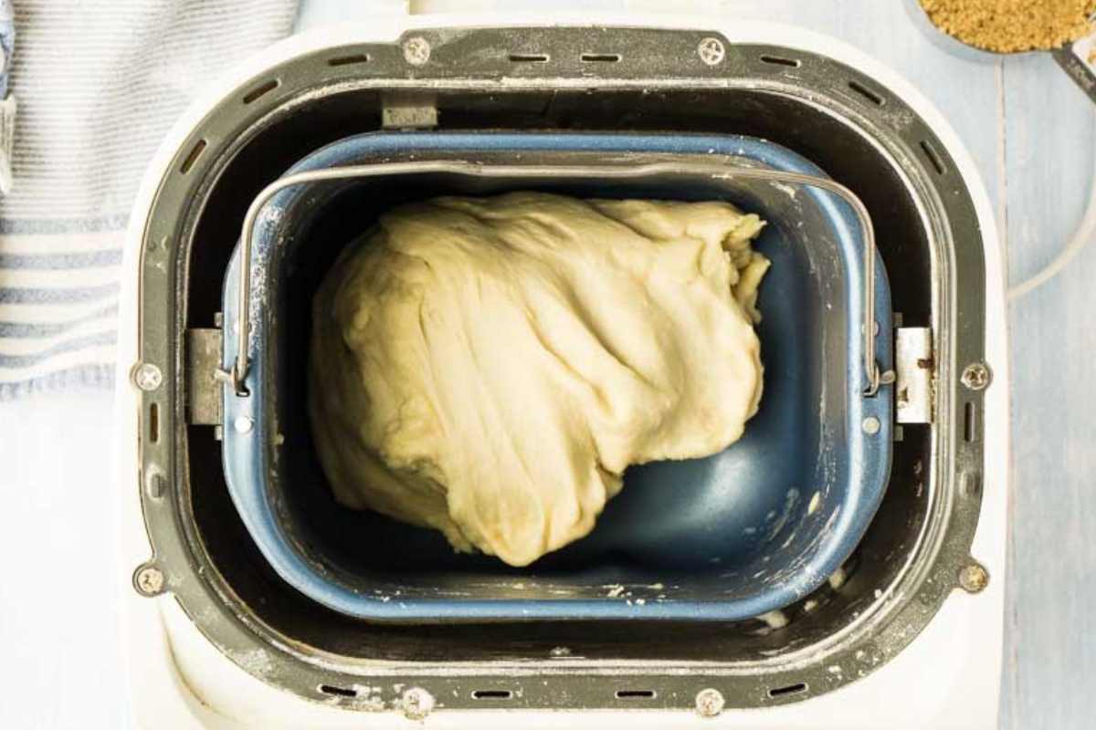 A close-up of risen dough inside a bread machine.