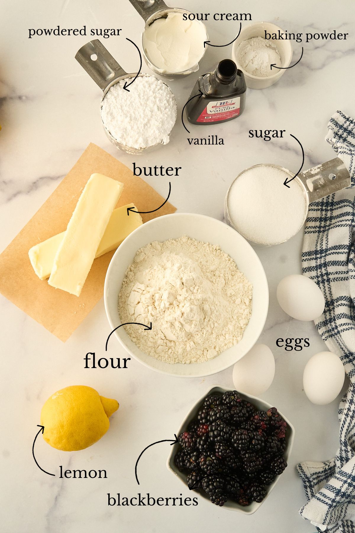 Ingredients for pound cake laid out on marble counter.