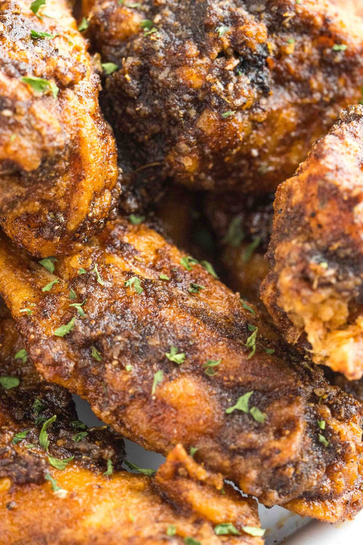 close up of crispy, Cajun seasoned chicken wings.