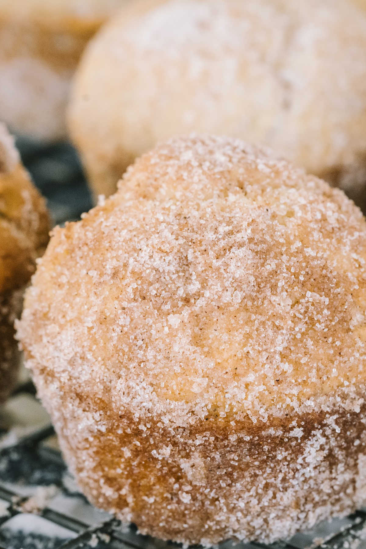 close up view of cinnamon sugar muffins on cooling rack