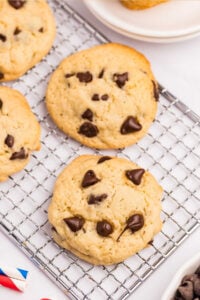 Sourdough Chocolate Chip Cookies on a cooling rack, showing their golden-brown edges and scattered chocolate chips.