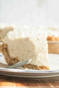 cream pie on small plate with bite missing