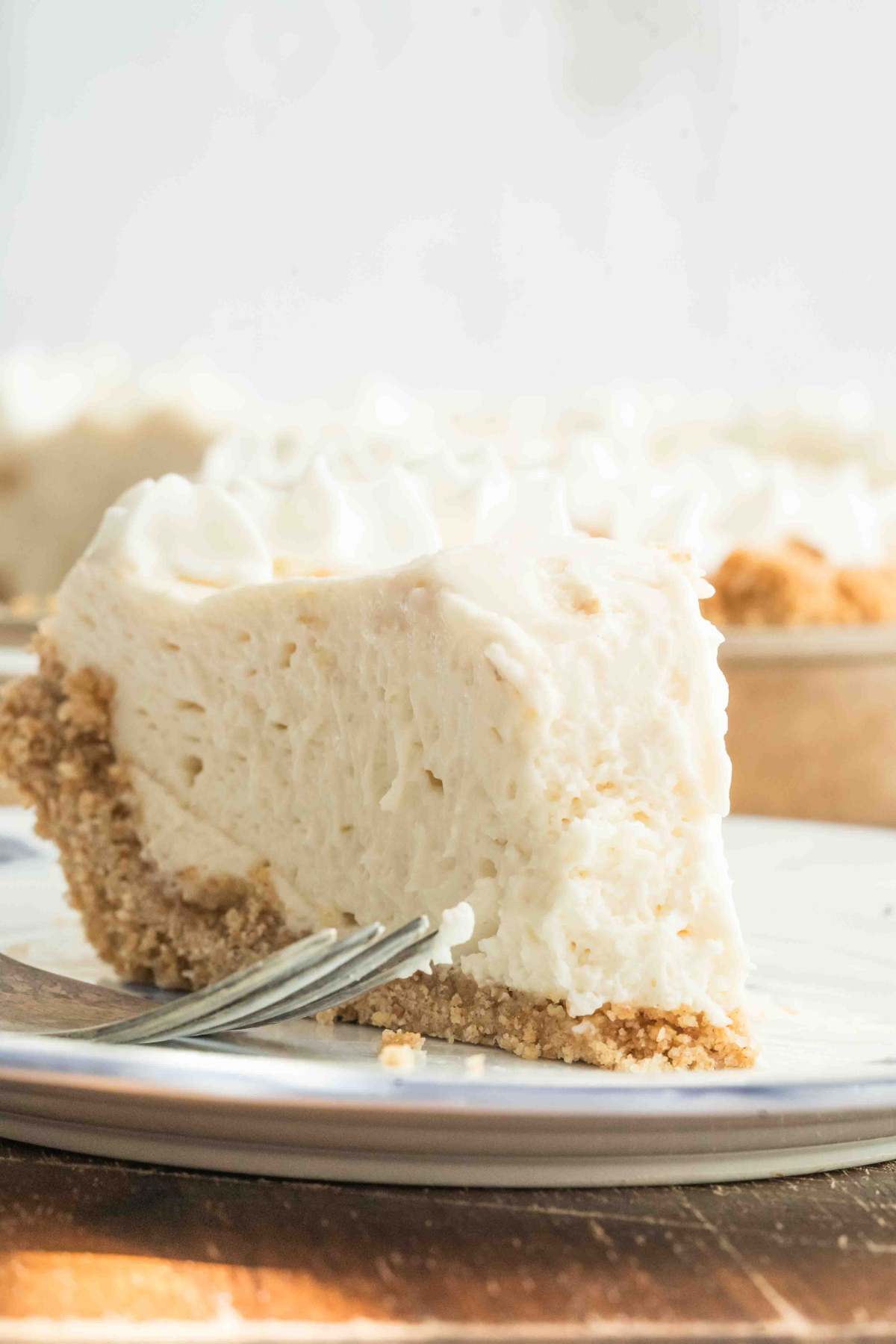 cream pie on small plate with bite missing