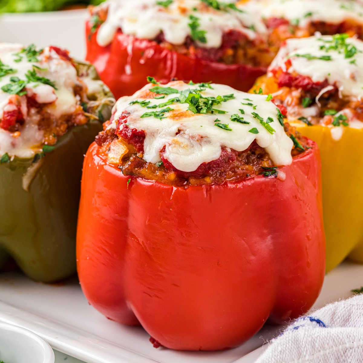 stuffed peppers with melted cheese on top.