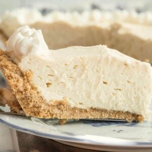 slice of creamy pie with graham cracker crust on pie server