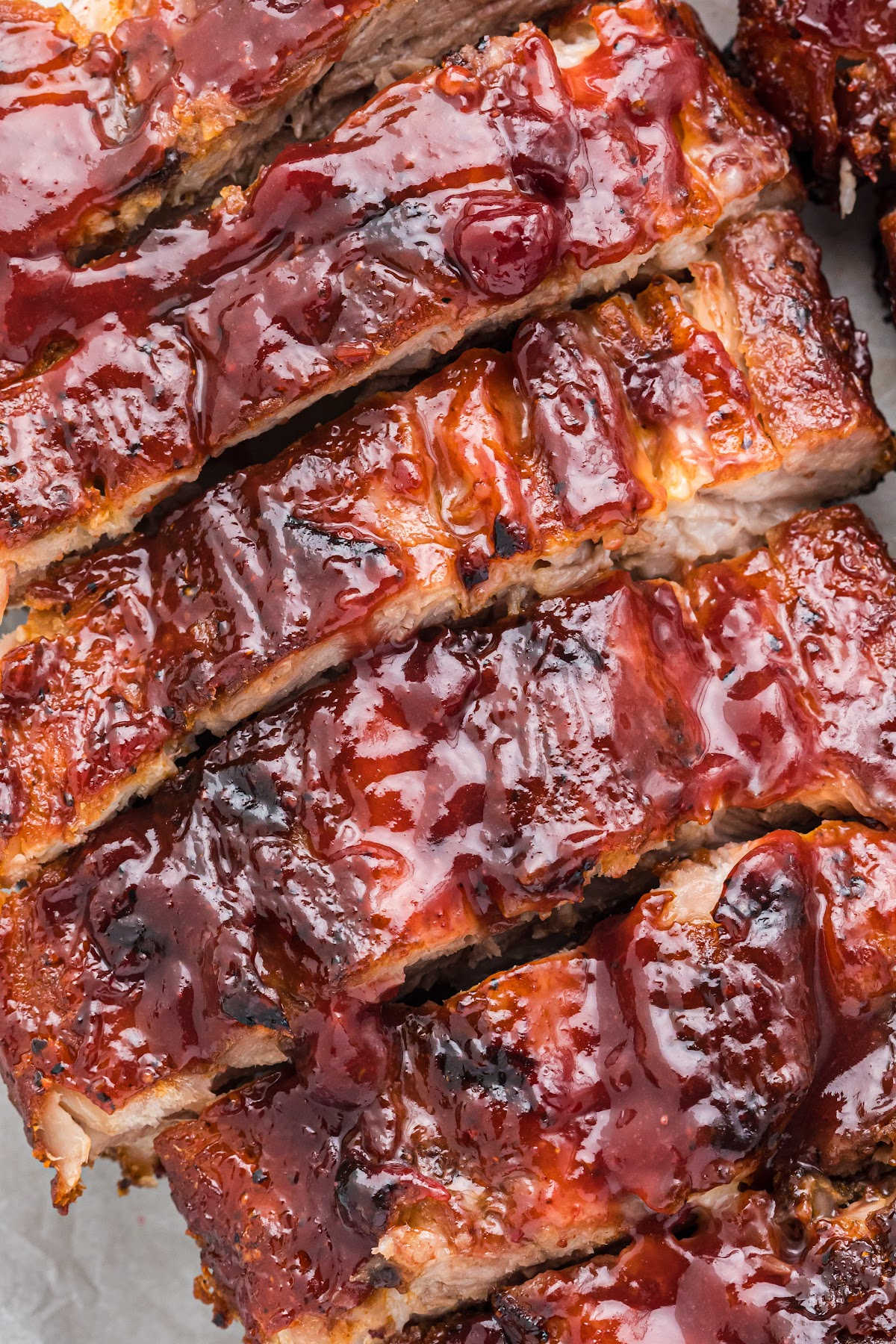 close up of cooked ribs with sauce, sliced up.
