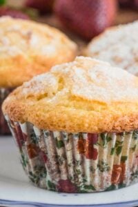 Close-up of a golden-brown muffin with a sugar topping, nestled in a floral-patterned paper liner.