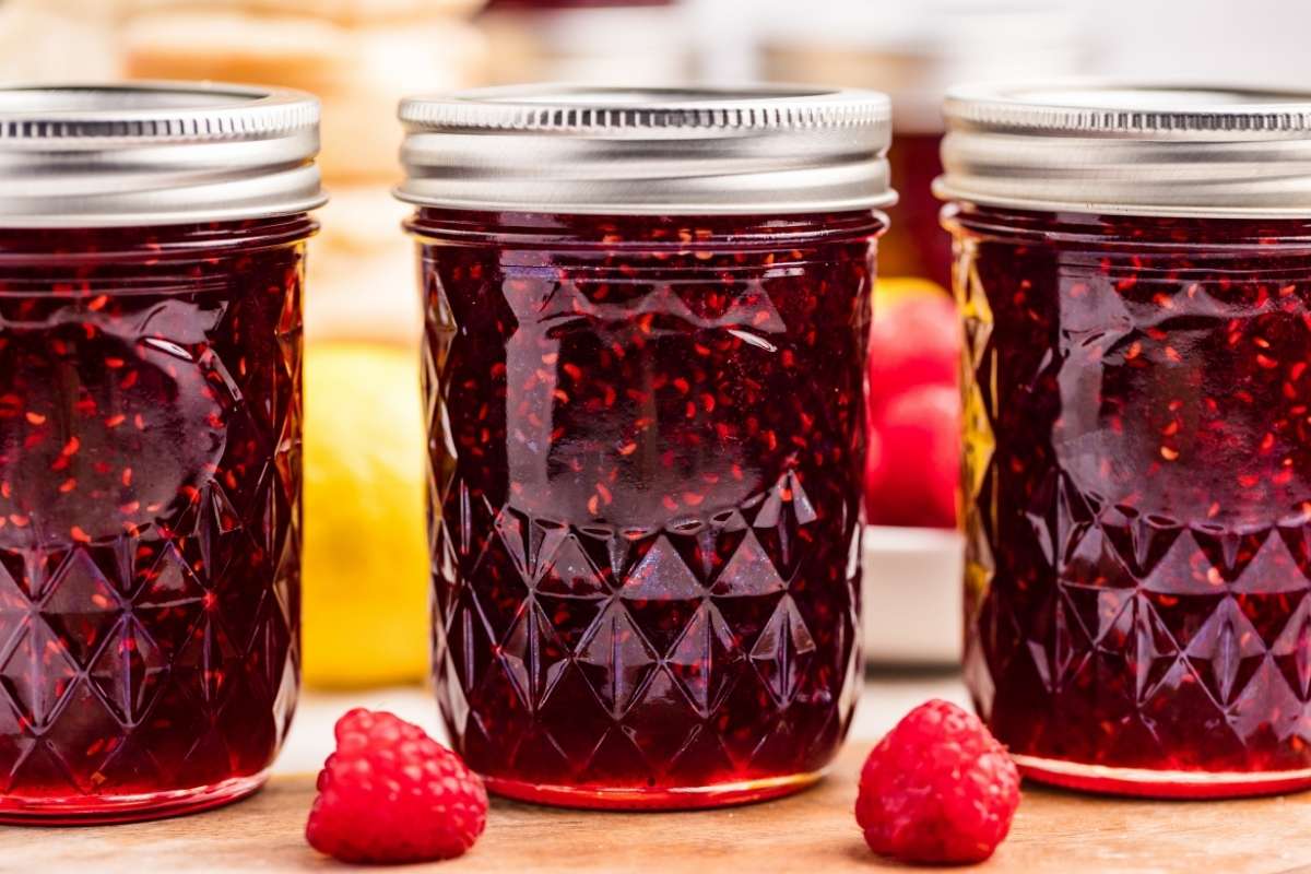Three jars of raspberry jam lined up 