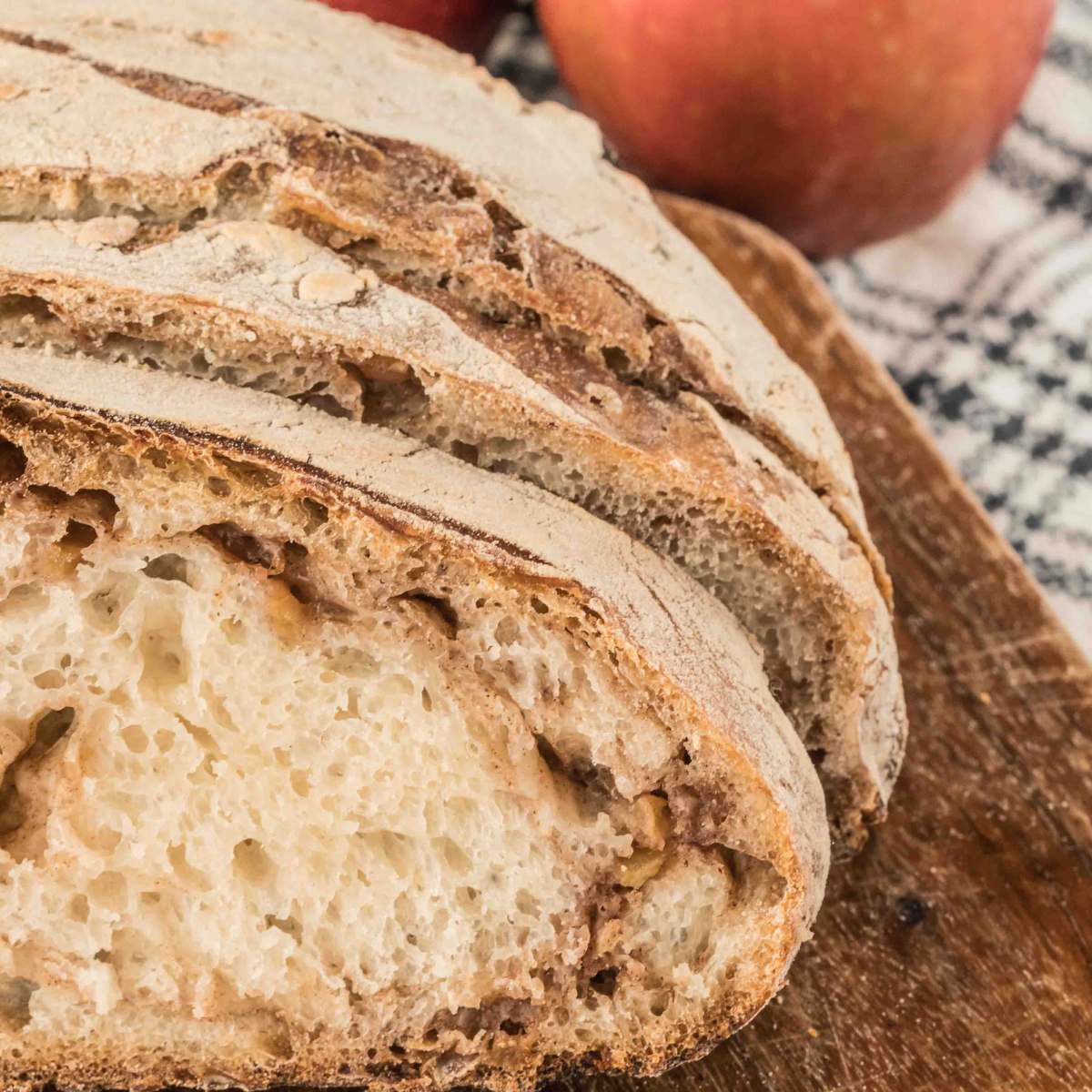 sliced apple cider loaf on wooden board.