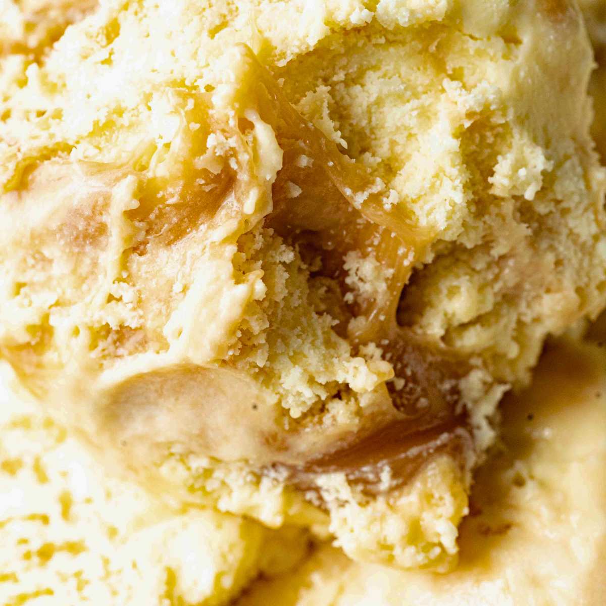 close up of vanilla ice cream with caramel ribbon through it.
