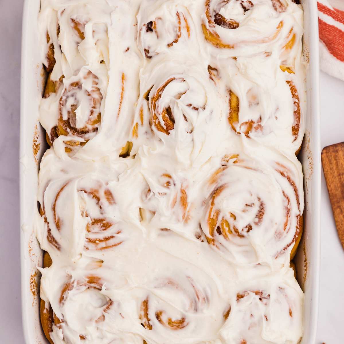 overhead shot of frosted cinnamon rolls.