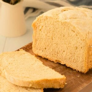 front close up of French bread loaf with two slices cut out.