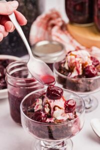 bourbon cherries drizzled over cups of ice cream.