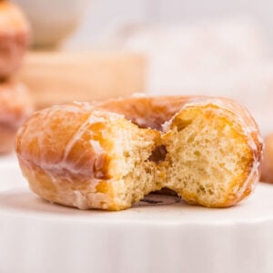 sourdough donut with bite missing.