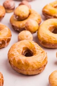 front shot of doughnuts and doughnut holes arranged on counter.