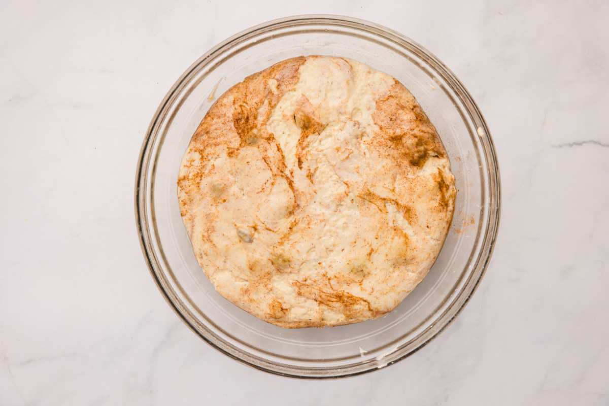cinnamon and raisin dough doubled in size in bowl.