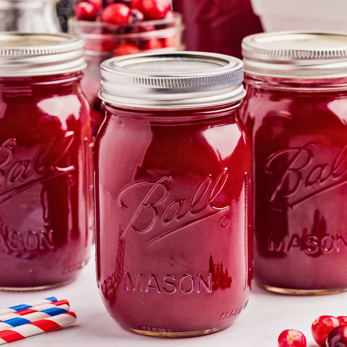 sealed jars of cranberry juice on counter.