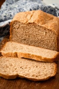 honey wheat bread loaf with two slices cut.