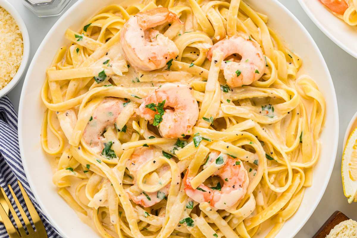 overhead of shrimp alfredo pasta in pasta bowl.