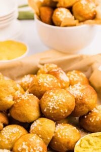 pretzel bites on baking sheet and in bowl in background.