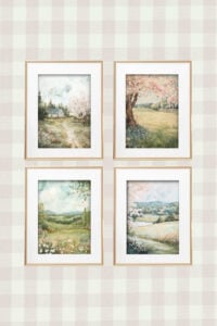A grid of four framed spring landscape watercolor paintings with soft pastel tones and blooming scenes, displayed on a patterned background.