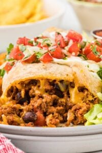 baked beef chimichanga on plate showing inside filling.